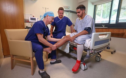 Professor Rodda and Dr Shane Blackmore with a young athlete after surgery