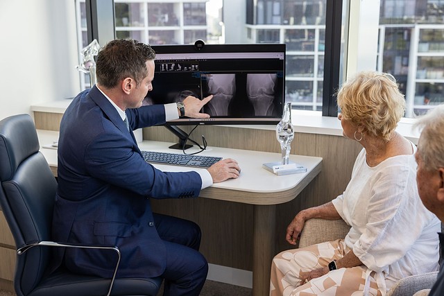 Professor Rodda reviewing a patient's X-rays with her in the rooms