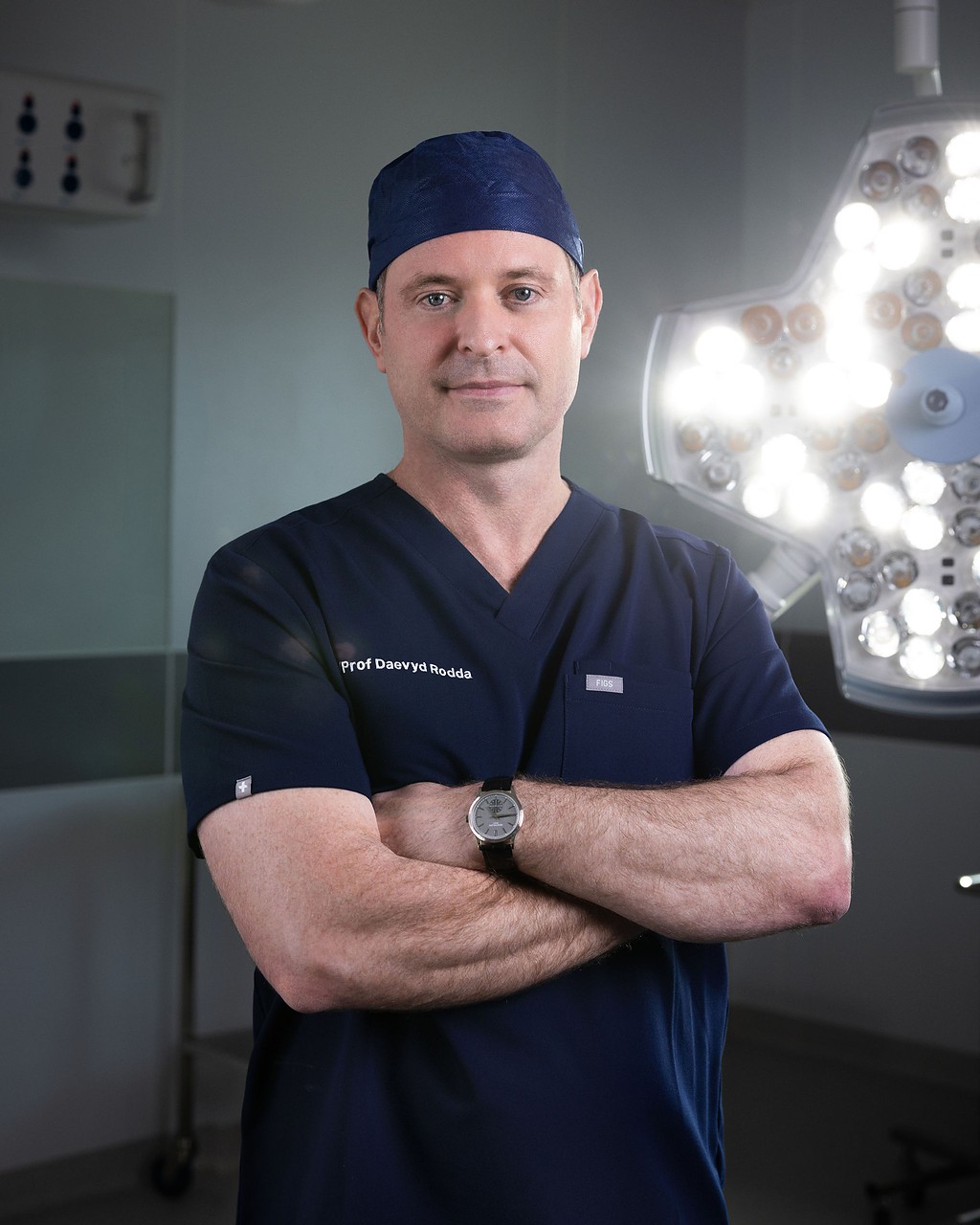 Professor Daevyd Rodda in theatre scrubs beneath the operating lights